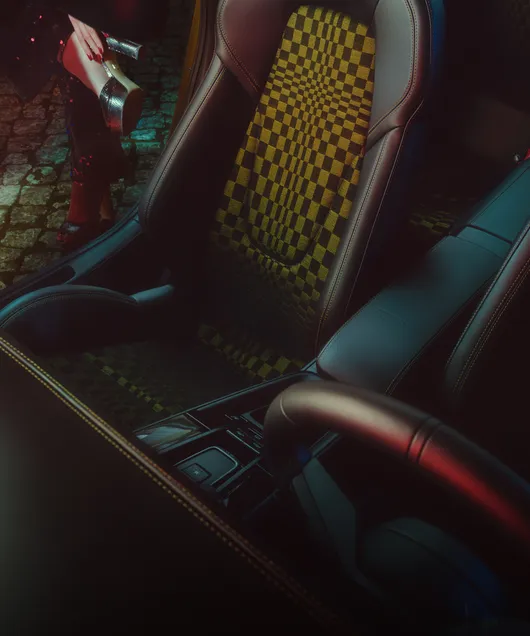 View of the passenger seat with Pasha pattern in the Porsche 911 Spirit 70. A woman's legs wearing gold platform shoes can be seen in the background.