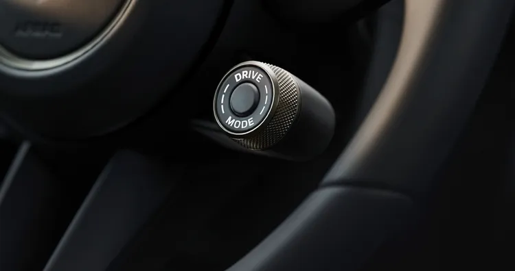 Detailed view of the drive mode switch on the steering wheel of the Porsche Panamera Turbo E-Hybrid.