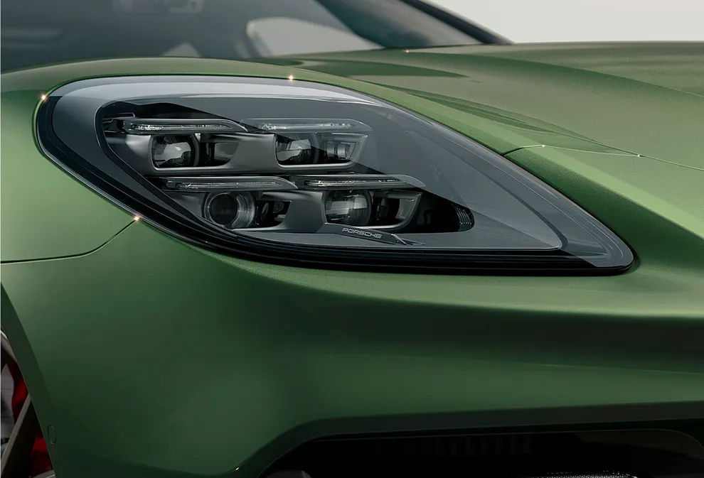 Detailed view of the Matrix LED headlight of a Porsche Panamera Turbo E-Hybrid Executive in Oak Green Metallic.
