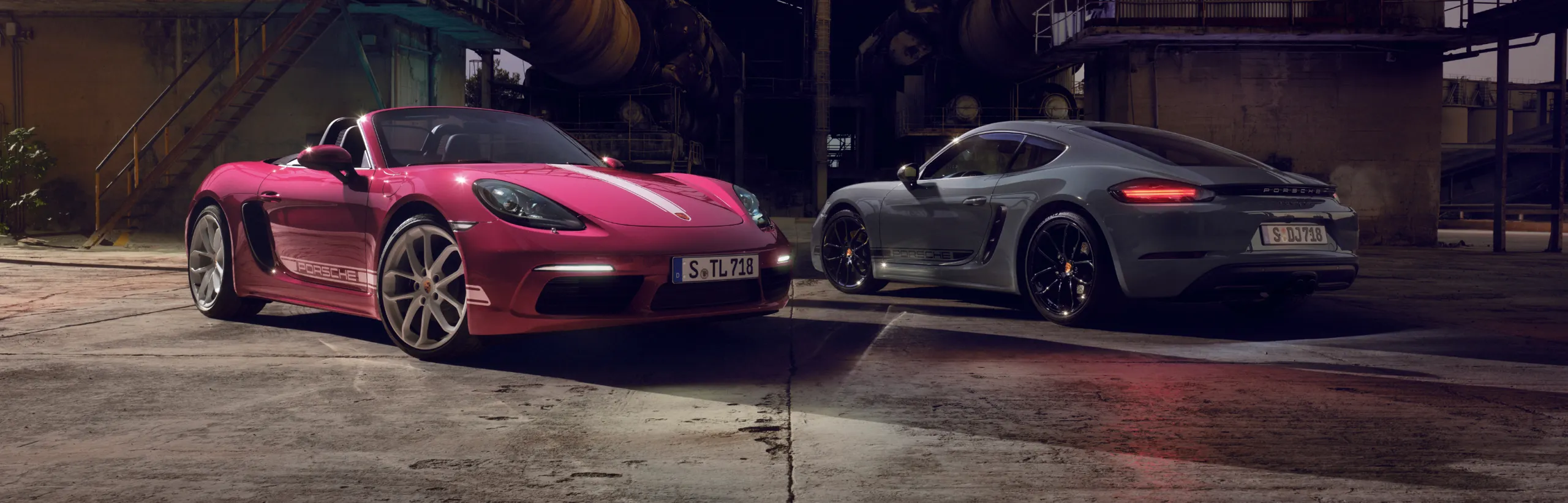 A Porsche 718 Cayman Style Edition in Arctic Gray and a Porsche 718 Boxster Style Edition in Star Ruby Neo driving side by side.