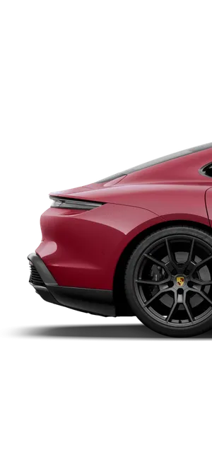 View of the side rear of the Porsche Taycan GTS in Carmine Red.