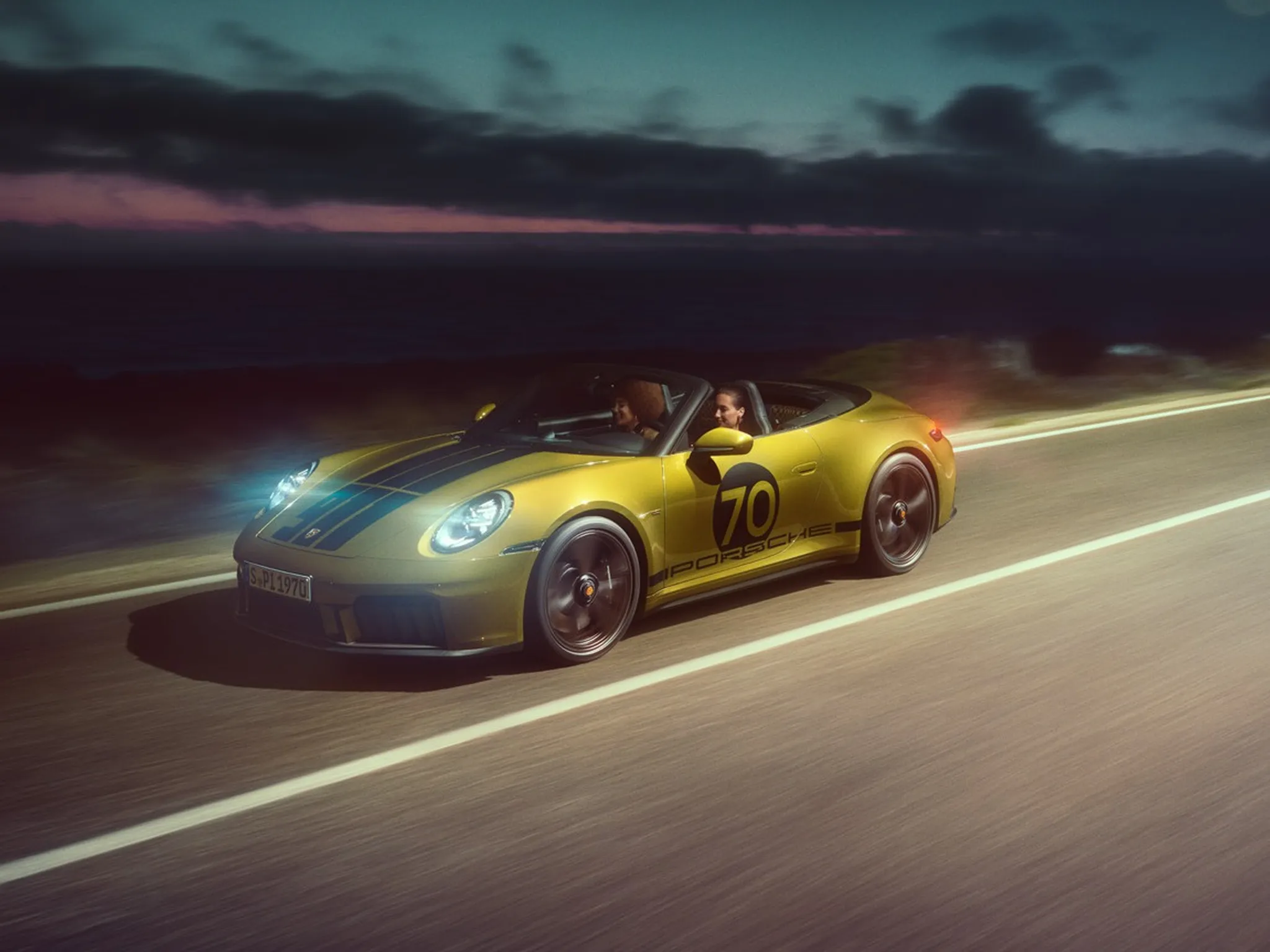 Side shot of a 911 Spirit 70 driving on a road at night. 